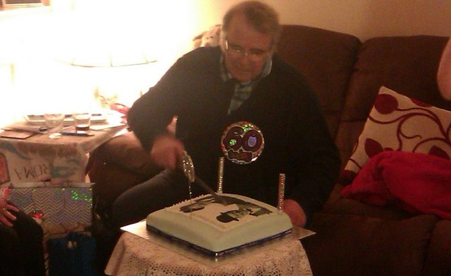 Paul cutting his cake.